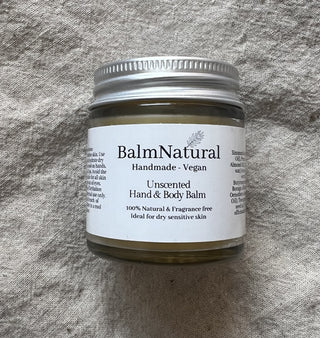 A jar of balmnatural unscented hand and body balm on cloth.  Vegan ointment balm for dry skin, Ideal for all the family