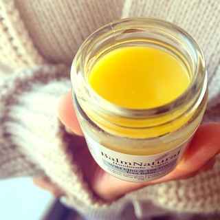 Image lady holding a jar of balm, Waterless skincare is great for your skin